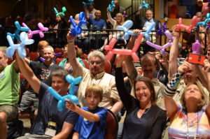 People holding balloon animals